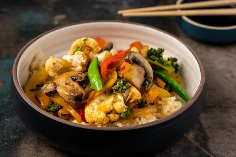Bowl of stir fried broccoli, mushrooms and peppers