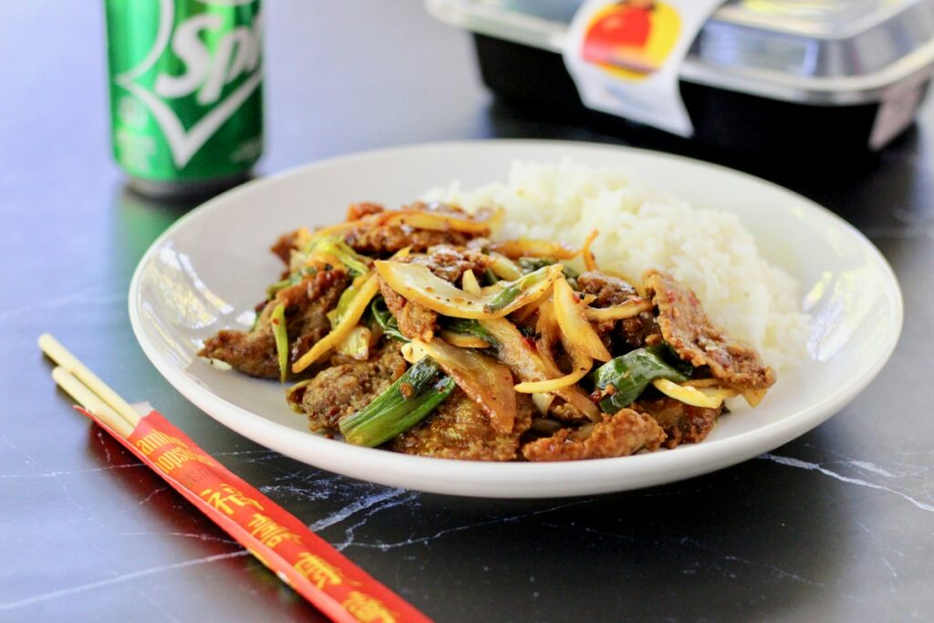 Stir-fried beef with rice on a white plate